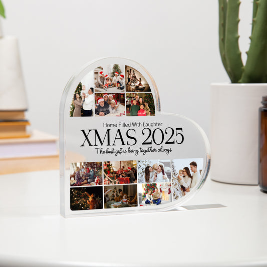 Heart-shaped photo collage display with 'XMAS 2025' text on a white surface.