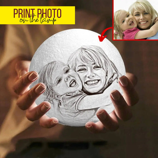 Custom moon lamp with engraved photo of mother and daughter hugging, glowing warmly in hands.