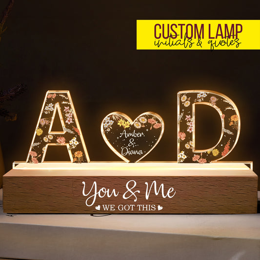 Engraved couple names light with floral details and heartfelt message on wooden base.