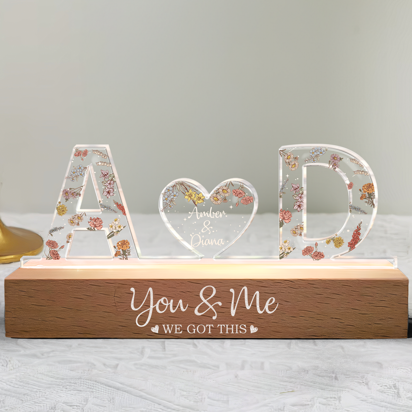 Romantic couple name light with glowing heart and wooden base inscribed with “You & Me – We Got This"