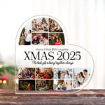 Personalized Christmas photo collage frame with family photos and text on a wooden surface.