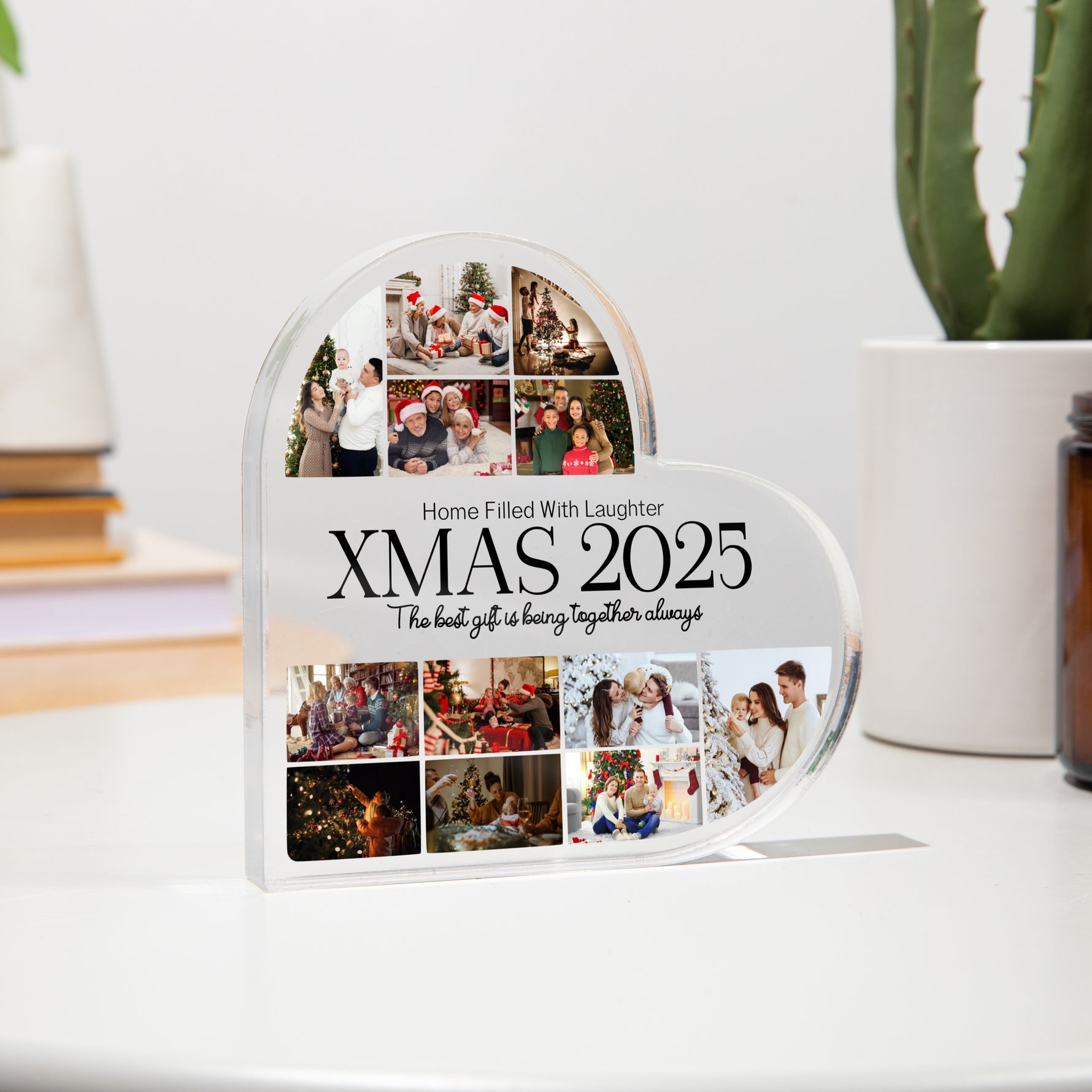 Heart-shaped photo collage display with 'XMAS 2025' text on a white surface.