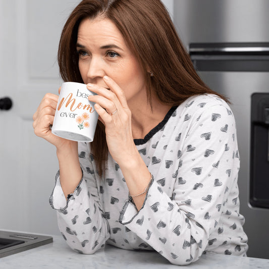 a mom is holding her best mom ever mug customised with name and her birth date