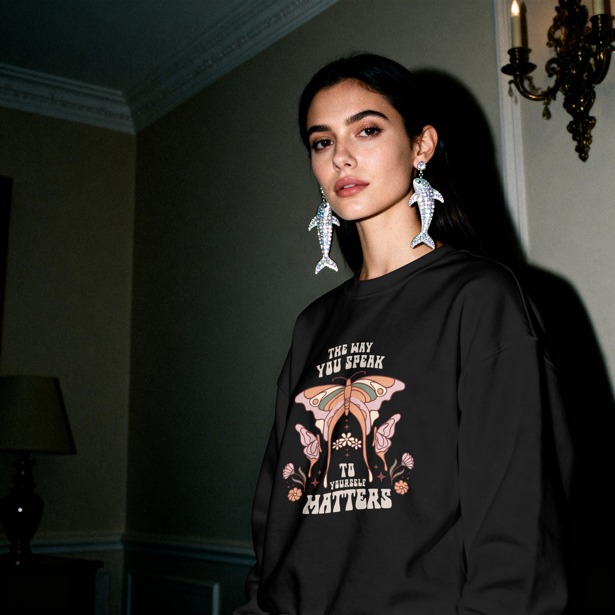 Self Love sweatshirt folded and held